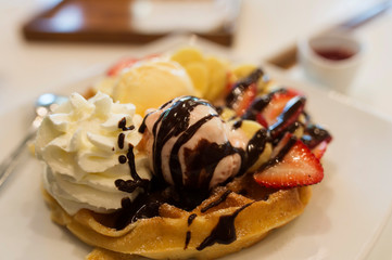 Sweet and cold dessert. Icecrean with toast and chocolate and wip cream