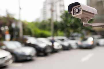 CCTV security camera on blur car parking