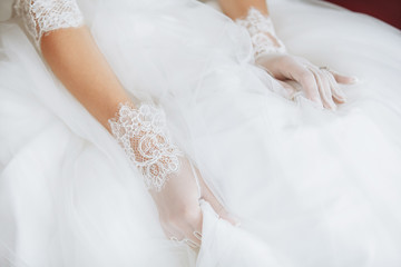 Obraz na płótnie Canvas dress of the bride and hands closeup