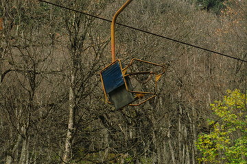 Chairlift on the Caucasus Mountains. Old unworking chairlift in the forest.