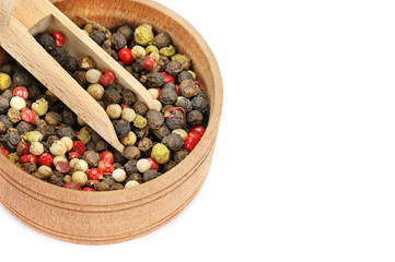 A mixture of allspice in wooden cup isolated on white background. Free space for text.