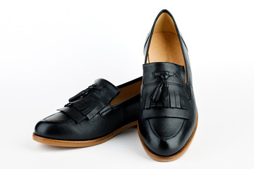 Women's black ballet flats on white background.