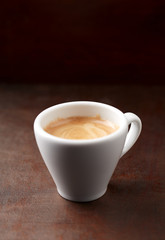 Cup of coffee on rustic wooden background. Copy space.