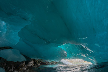 beautiful blue ice glacier cave grotto inside the mountain glacier Alibek, Dombay