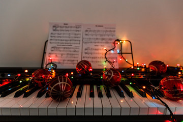 A piano with christmas lights and tree