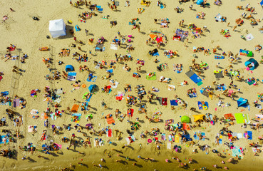 Top view of the beach with overflows and people swimming in the Baltic Sea of the city of Gdynia,...