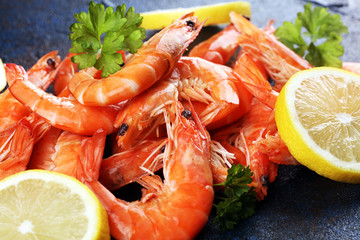 Raw fresh Prawns Langostino Austral. shrimp seafood with lemon and spices on dark