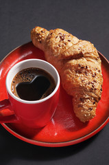 Cup of coffee and croissant