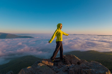 A woman on top mountain, summer cloudscape