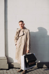 A stylish young man with bags after successful shopping on Black Friday