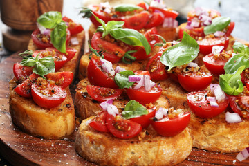 fresh tomato bruschetta. italian food appetizer with basil on table
