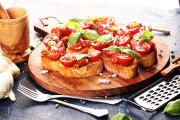 fresh tomato bruschetta. italian food appetizer with basil on table
