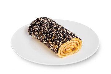 Sponge biscuit roll lies on a white plate on a white background. Biscuit roll on a white plate.