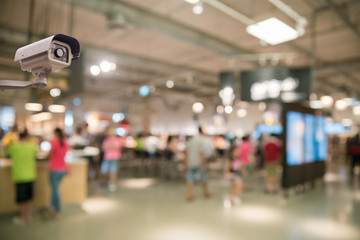 CCTV security camera on blur shopping mall background