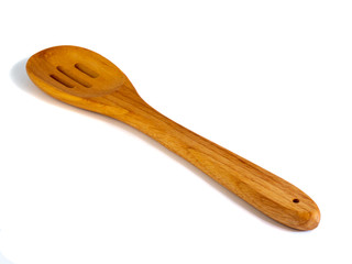 Wooden pasta slotted spoon isolated on a white background.