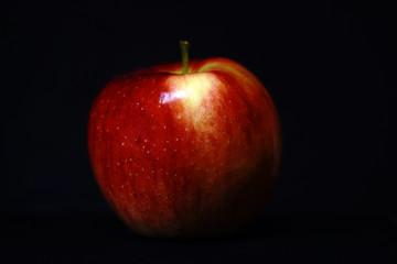 red apple on black background