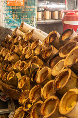 Chon Buri, Thailand - March 16, 2019: Closeup of light brown stack of empty bamboo cake holders on street market in Sukhumvit Road.