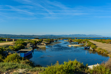 Boat on a Canal in Ebro Delta estuary and wetlands, Tarragona, Catalunya, Spain.