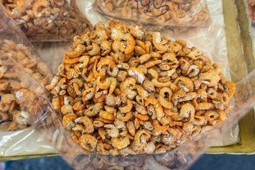 Chon Buri, Thailand - March 16, 2019: Closeup of heap of small orange-yellow shrimp on display at street market in Sukhumvit Road.