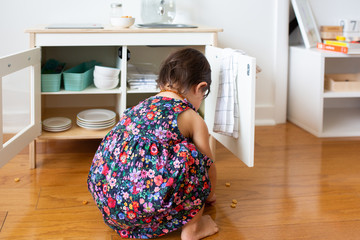 Fototapeta na wymiar Toddler Girl with Play Kitchen