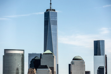 Low angle view of One World Trade Center in city against blue sky