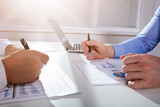 Businessman Analyzing The Business Graph At Work Place