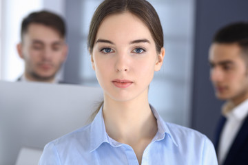 Business woman and group of diverse business people at the background in modern office. Multi ethnic teamwork and business concept