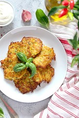 Fried potato pancakes on light background. Top view with copy space.