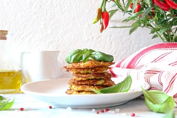 Fried potato pancakes on light background. Top view with copy space.