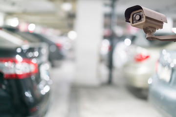 CCTV security camera on blue car parking background
