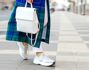 Fashionable bag close-up in female hands.Girl walks in the city outdoors. Stylish modern and...