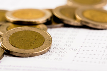Money pile coins on account book bank close up