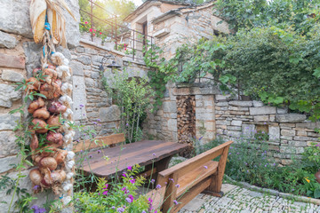 Beautfiful garden in ethno village with a table and chairs, croatia 