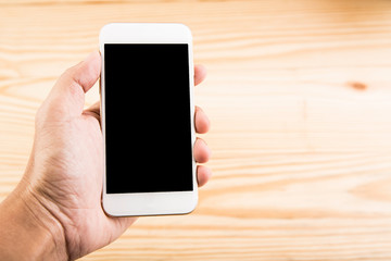 Hand hold blank smartphone on wooden background
