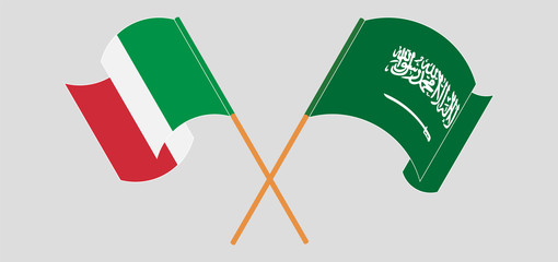 Crossed and waving flags of the Kingdom of Saudi Arabia and Italy