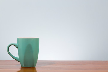 Empty coffee mug on wooden table
