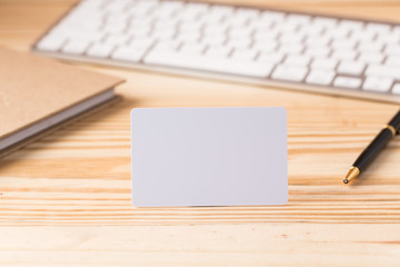 Blank credit card on office table with keyboard and note book