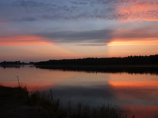 Fototapeta na wymiar Red-orange sunset on the river