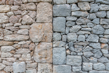 Old stone wall of stones with different stone colors