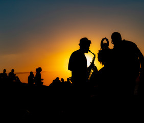 músicos cantando no pôr do sol