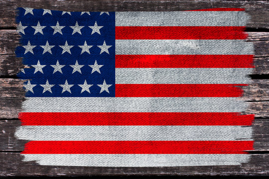 photo of the beautiful colored national flag of the modern state of USA on textured fabric, concept of tourism, emigration, economics and politics, closeup