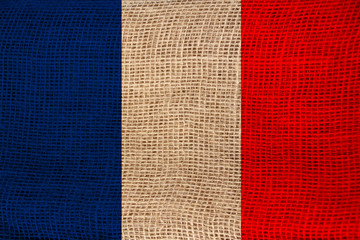 photo of the beautiful colored national flag of the modern state of France on textured fabric, concept of tourism, emigration, economics and politics, closeup