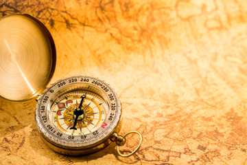 Fototapeta na wymiar Vintage compass on grunge global map