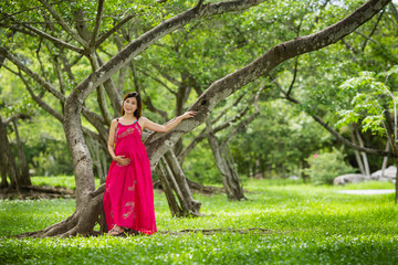 Portrait asian beautiful belly pregnant in public park