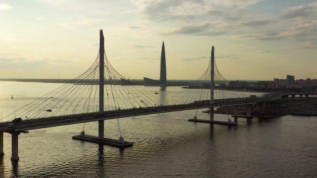 Aerial view of cable-stayed bridge and new skyscraper in St.Petersburg during sunset, 4k