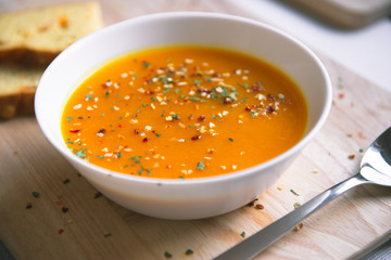 Closeup photo of seasonal autumn pumpkin soup and homemade pumpkin bread