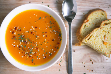 Closeup photo of seasonal autumn pumpkin soup and homemade pumpkin bread