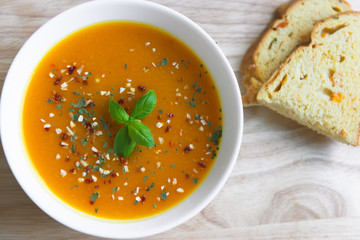 Closeup photo of seasonal autumn pumpkin soup and homemade pumpkin bread
