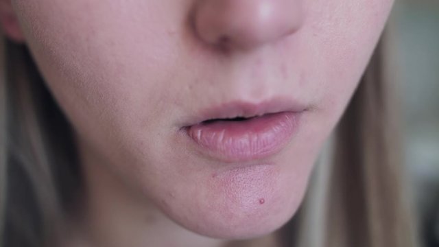 Close view of unrecognizable woman takes medicine and drinks water