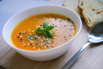 Closeup photo of seasonal autumn pumpkin soup and homemade pumpkin bread
